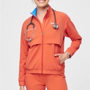 Figs Sydney scrub jacket in sunset orange.